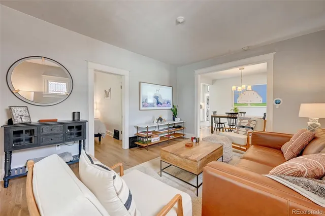 a living room with furniture and a mirror