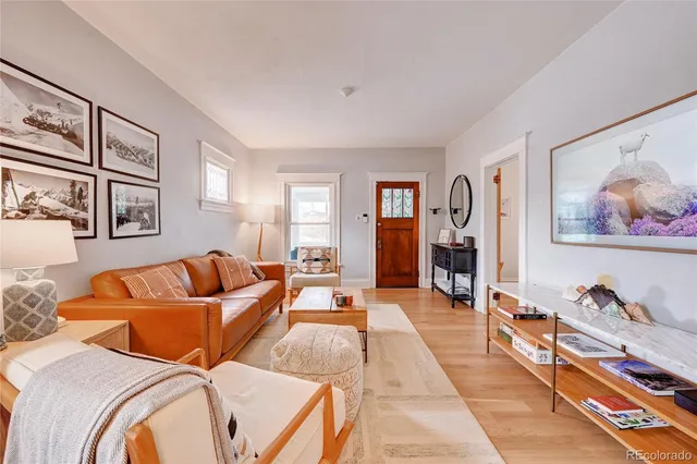 a living room with furniture two couch and a window