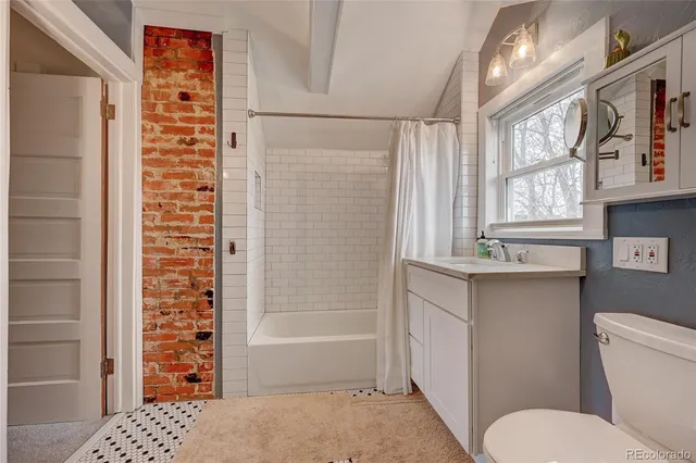 a bathroom with a toilet a sink and a shower