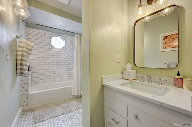 a bathroom with a sink a shower and a mirror