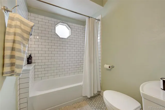 a bathroom with a toilet and a bathtub