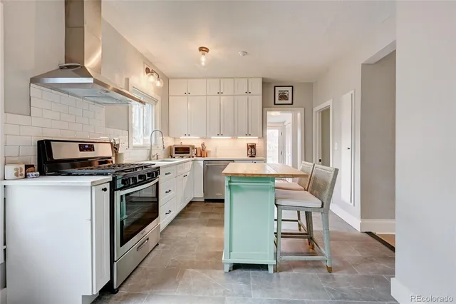 a kitchen with a sink cabinets and window