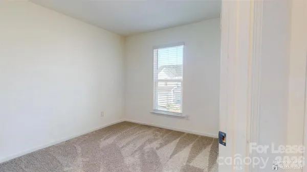 a view of an empty room and a window