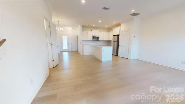 a view of a kitchen with a sink and cabinets