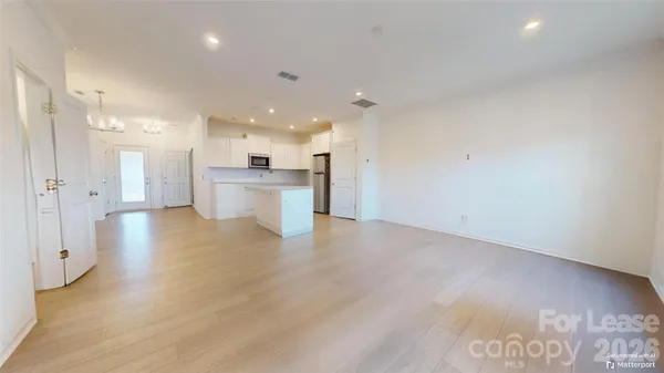 a view of a kitchen with a sink and a refrigerator