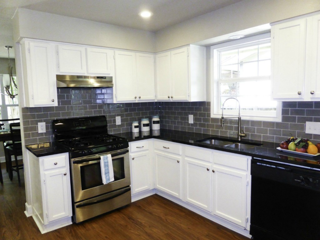 13169 Mill Stone Drive Austin, TX 78717 - Photo 4 of 8 a kitchen with granite countertop a sink and a stove top oven