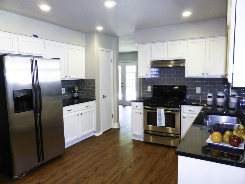 13169 Mill Stone Drive Austin, TX 78717 - Photo 5 of 8 a kitchen with stainless steel appliances kitchen island granite countertop a refrigerator stove and sink