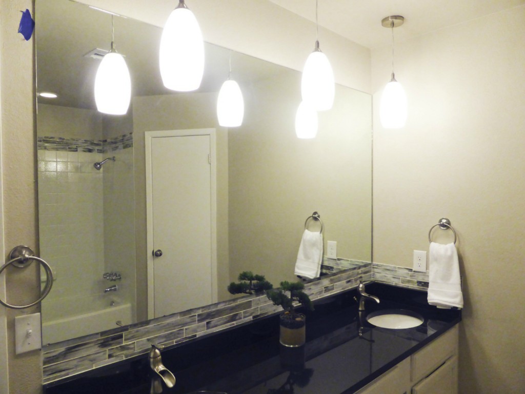 13169 Mill Stone Drive Austin, TX 78717 - Photo 6 of 8 a bathroom with a sink a light fixture and a mirror