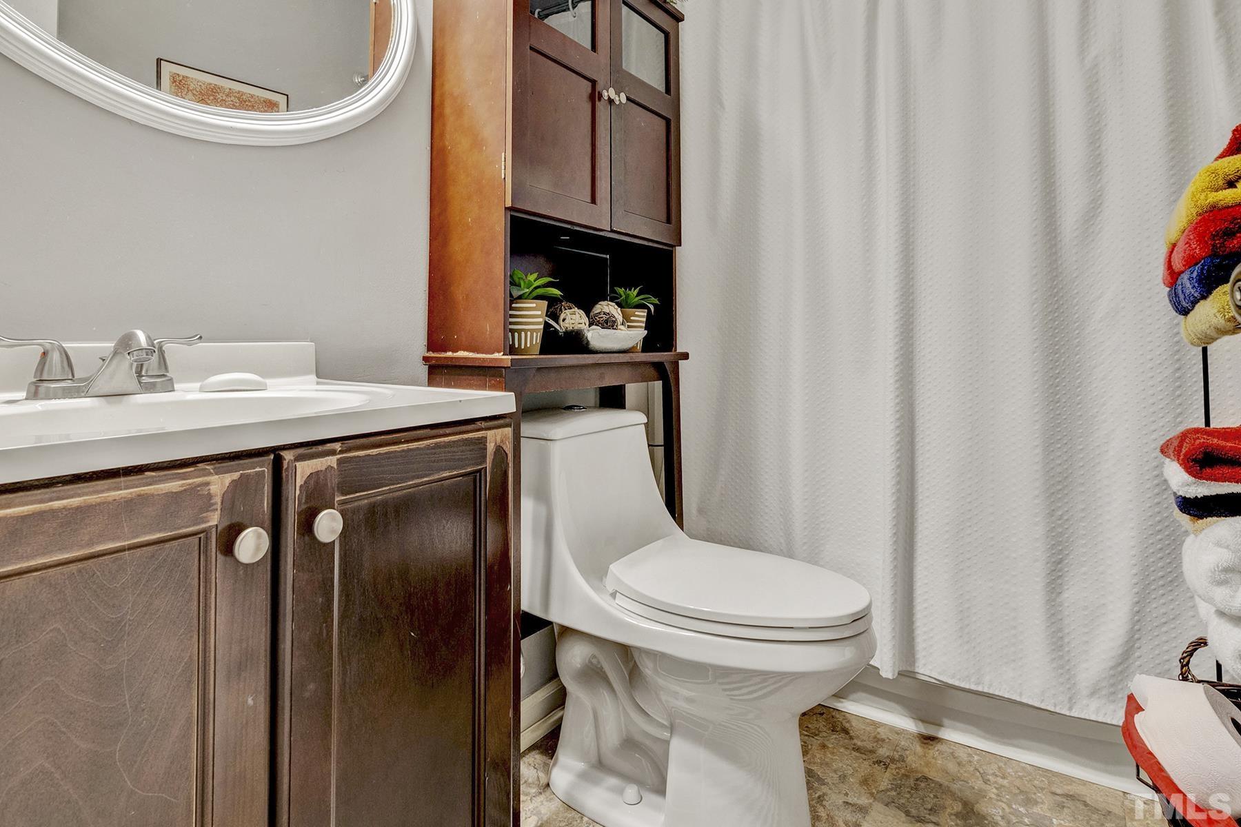 27 Sunflower Court Durham, NC 27713 - Photo 15 of 18 a bathroom with a granite countertop toilet sink and mirror