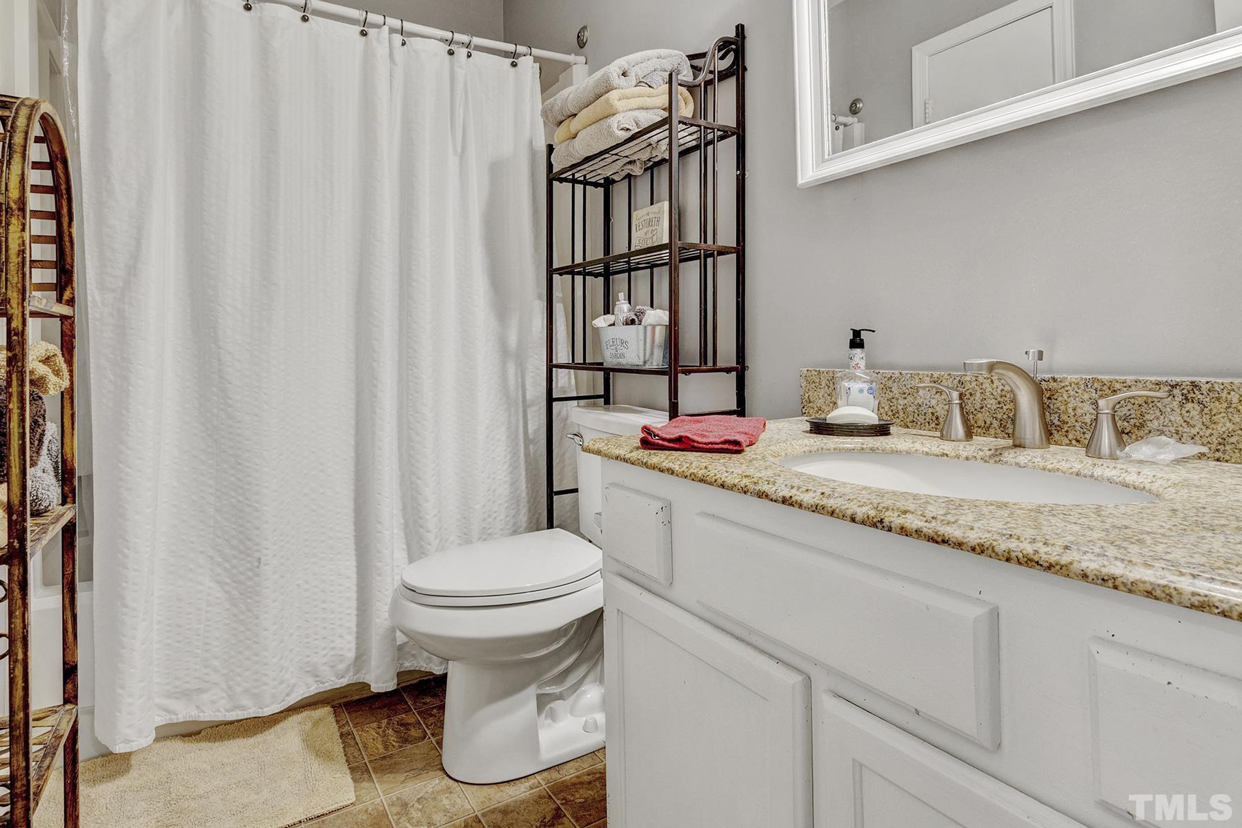 27 Sunflower Court Durham, NC 27713 - Photo 16 of 18 a bathroom with a granite countertop sink and a toilet