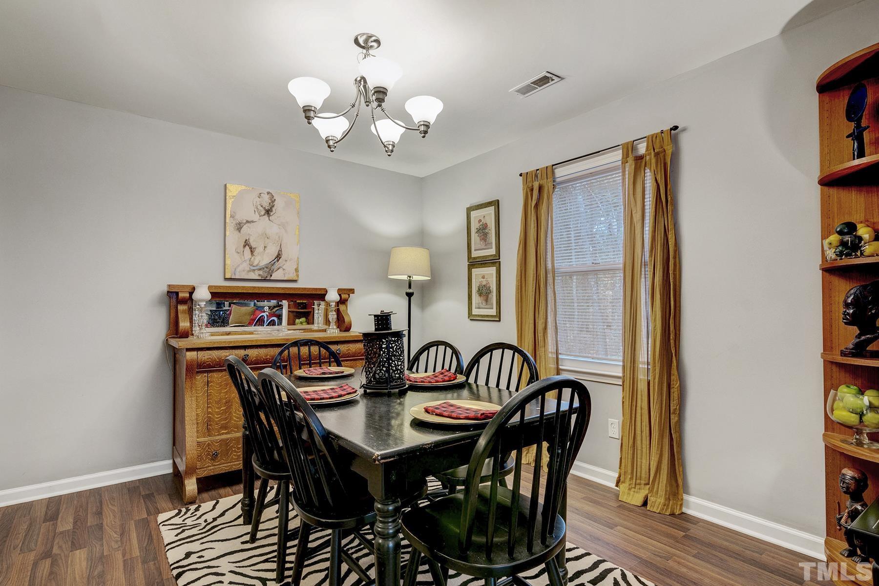 27 Sunflower Court Durham, NC 27713 - Photo 5 of 18 a view of a dining room with furniture and chandelier