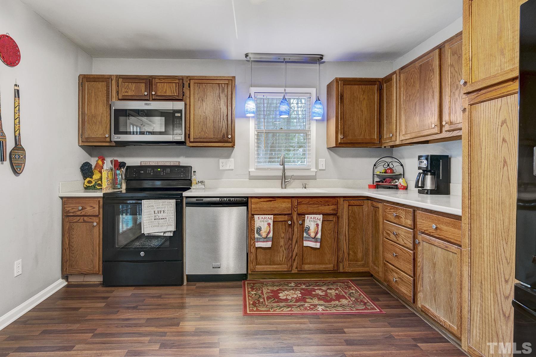 27 Sunflower Court Durham, NC 27713 - Photo 7 of 18 a kitchen with stainless steel appliances granite countertop a refrigerator stove and sink