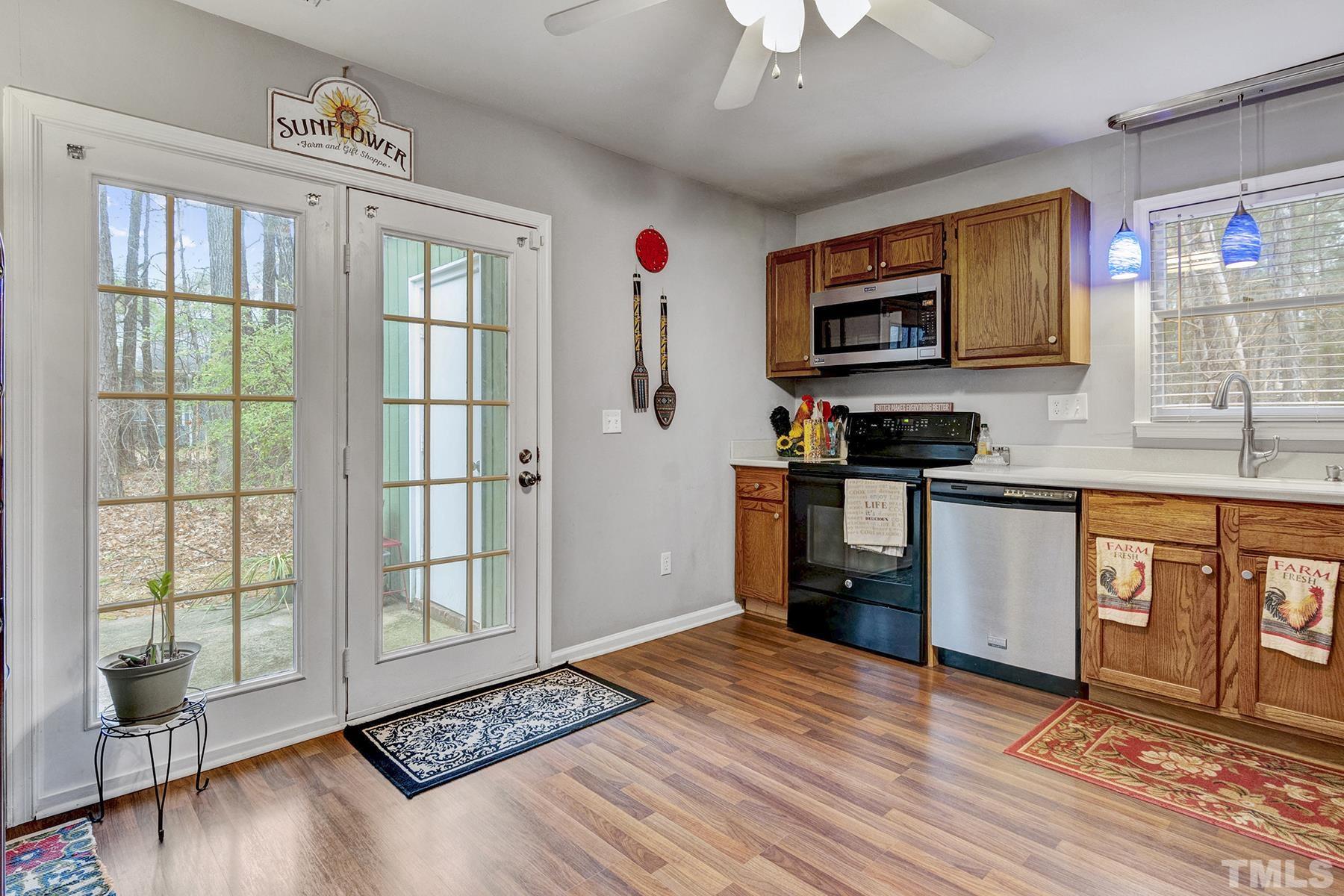 27 Sunflower Court Durham, NC 27713 - Photo 9 of 18 a kitchen with stainless steel appliances granite countertop a stove a sink and a refrigerator