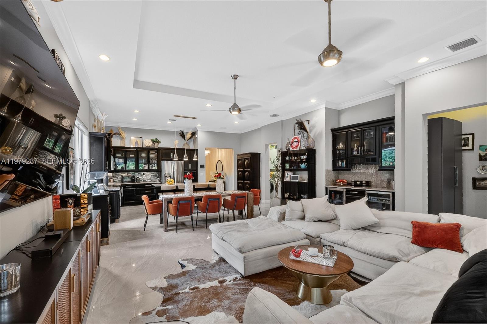 14929 Southwest 176th Terrace Miami, FL 33187 - Photo 11 of 40 a living room with furniture kitchen view and a large window