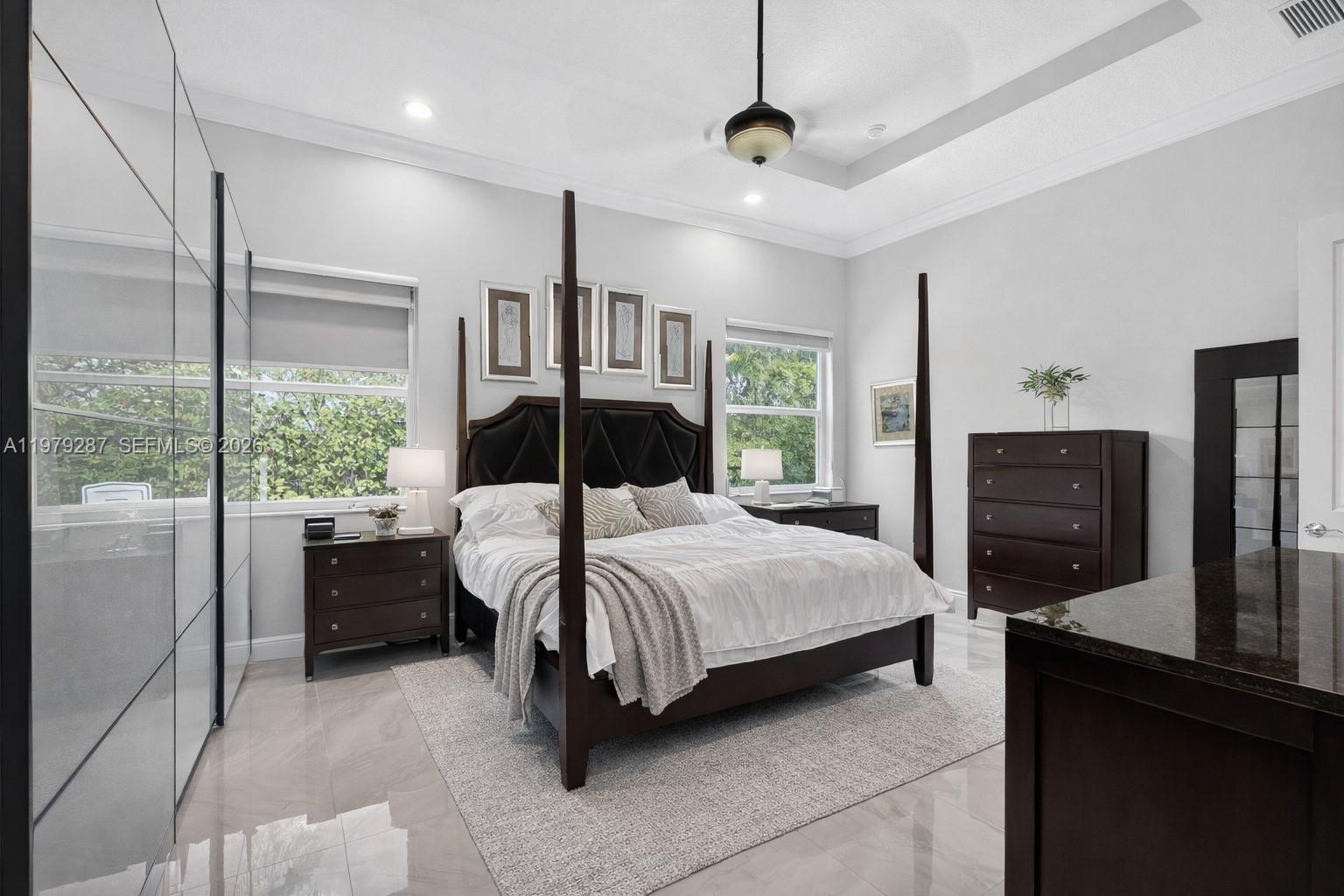 14929 Southwest 176th Terrace Miami, FL 33187 - Photo 13 of 40 a bedroom with a bed dresser and a flat tv screen