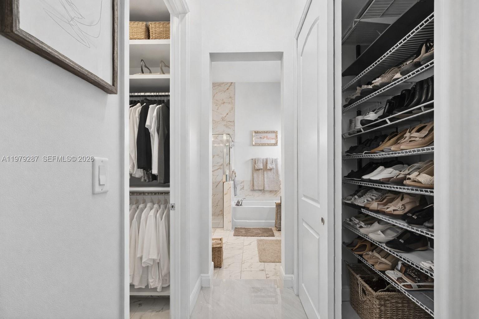 14929 Southwest 176th Terrace Miami, FL 33187 - Photo 14 of 40 a view of walk in closet with clothes and shoes