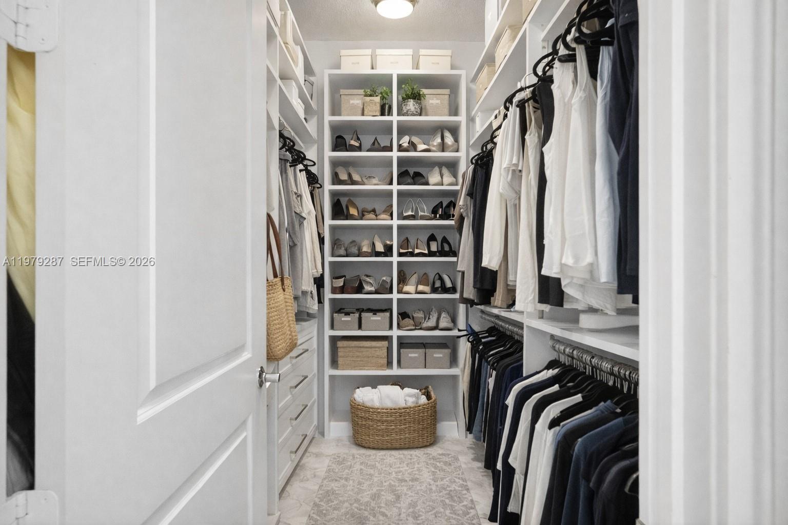 14929 Southwest 176th Terrace Miami, FL 33187 - Photo 19 of 40 a view of walk in closet with clothes and shoes