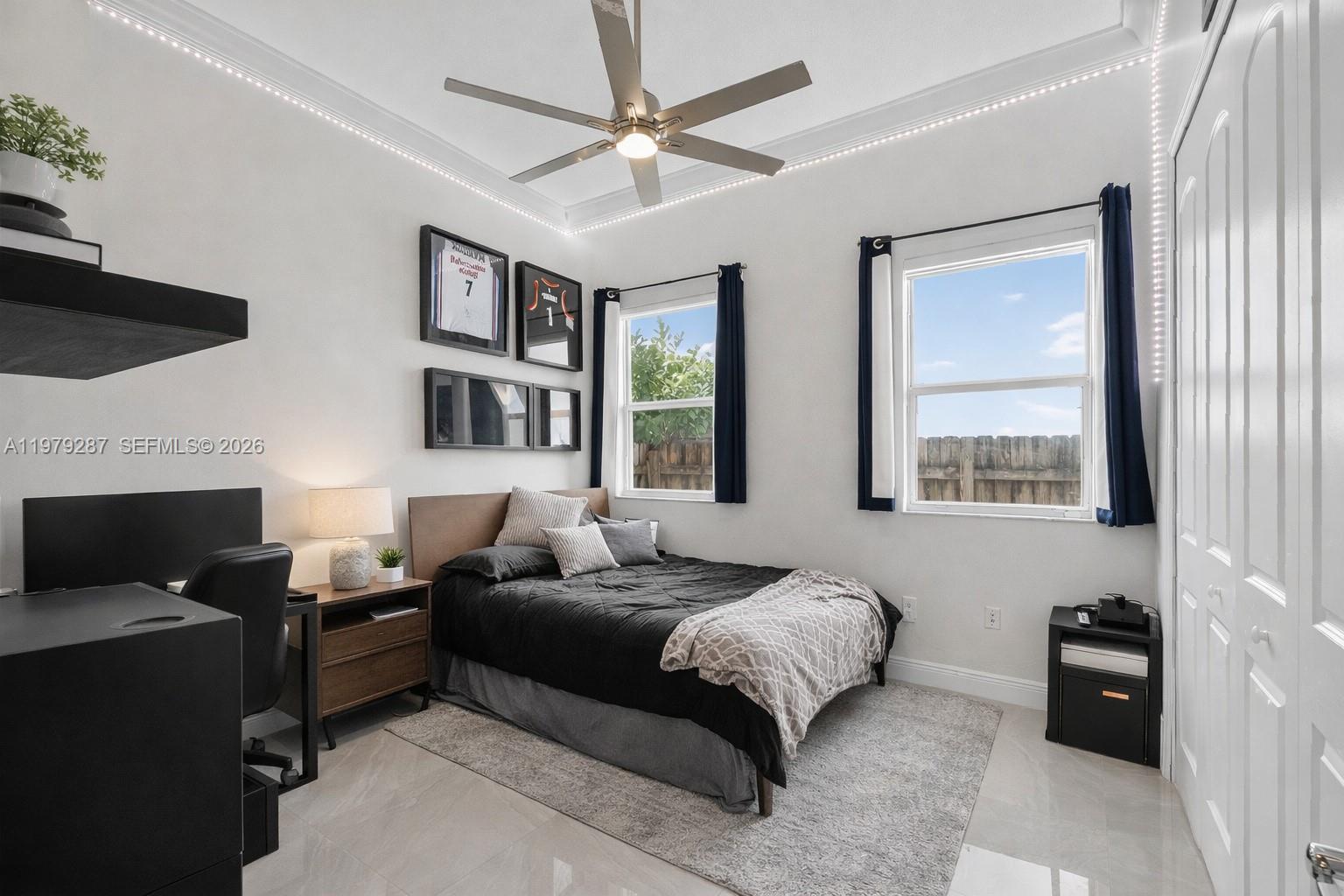 14929 Southwest 176th Terrace Miami, FL 33187 - Photo 20 of 40 a bedroom with a bed couch and window