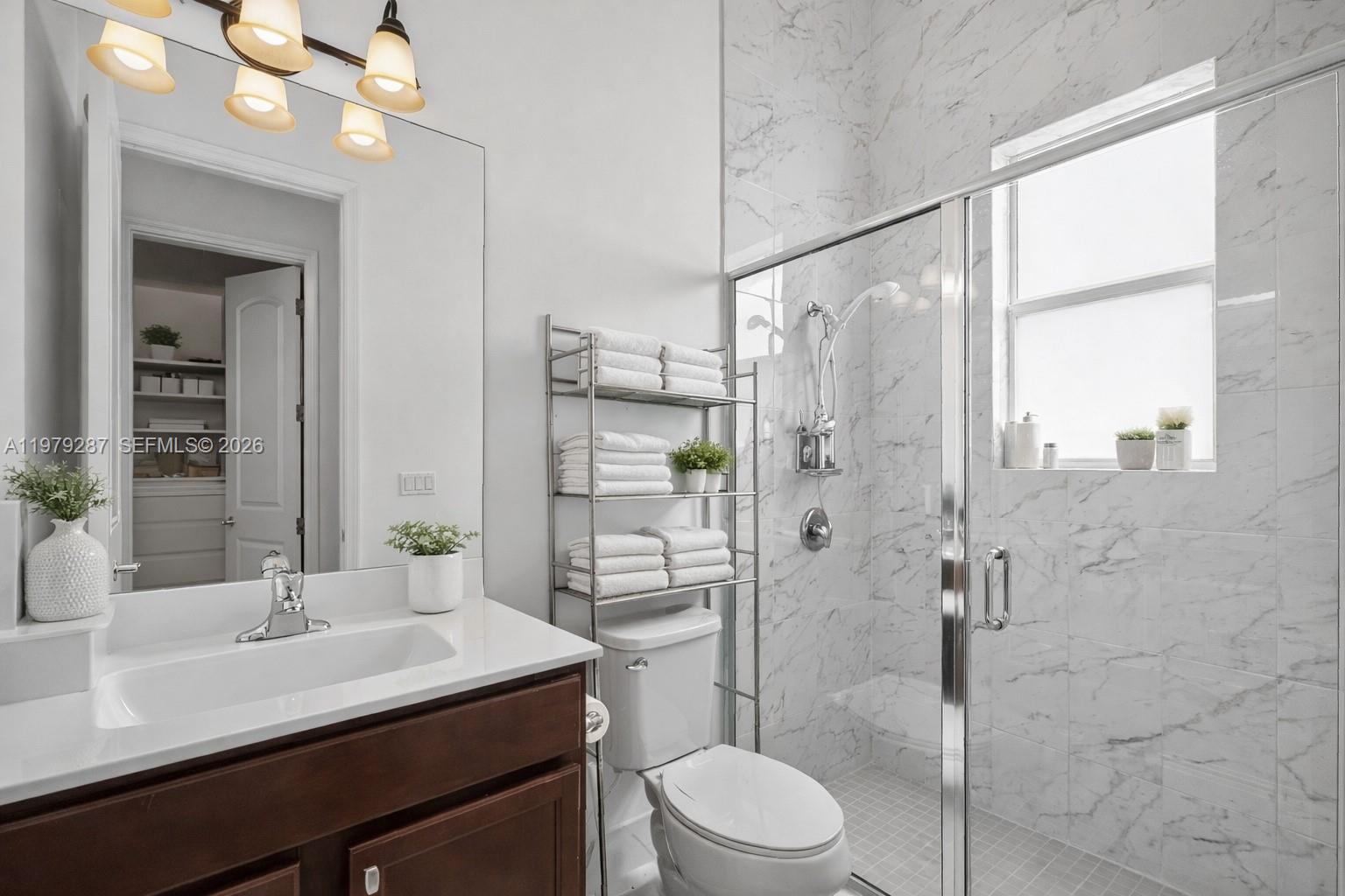 14929 Southwest 176th Terrace Miami, FL 33187 - Photo 24 of 40 a bathroom with a sink a toilet and shower