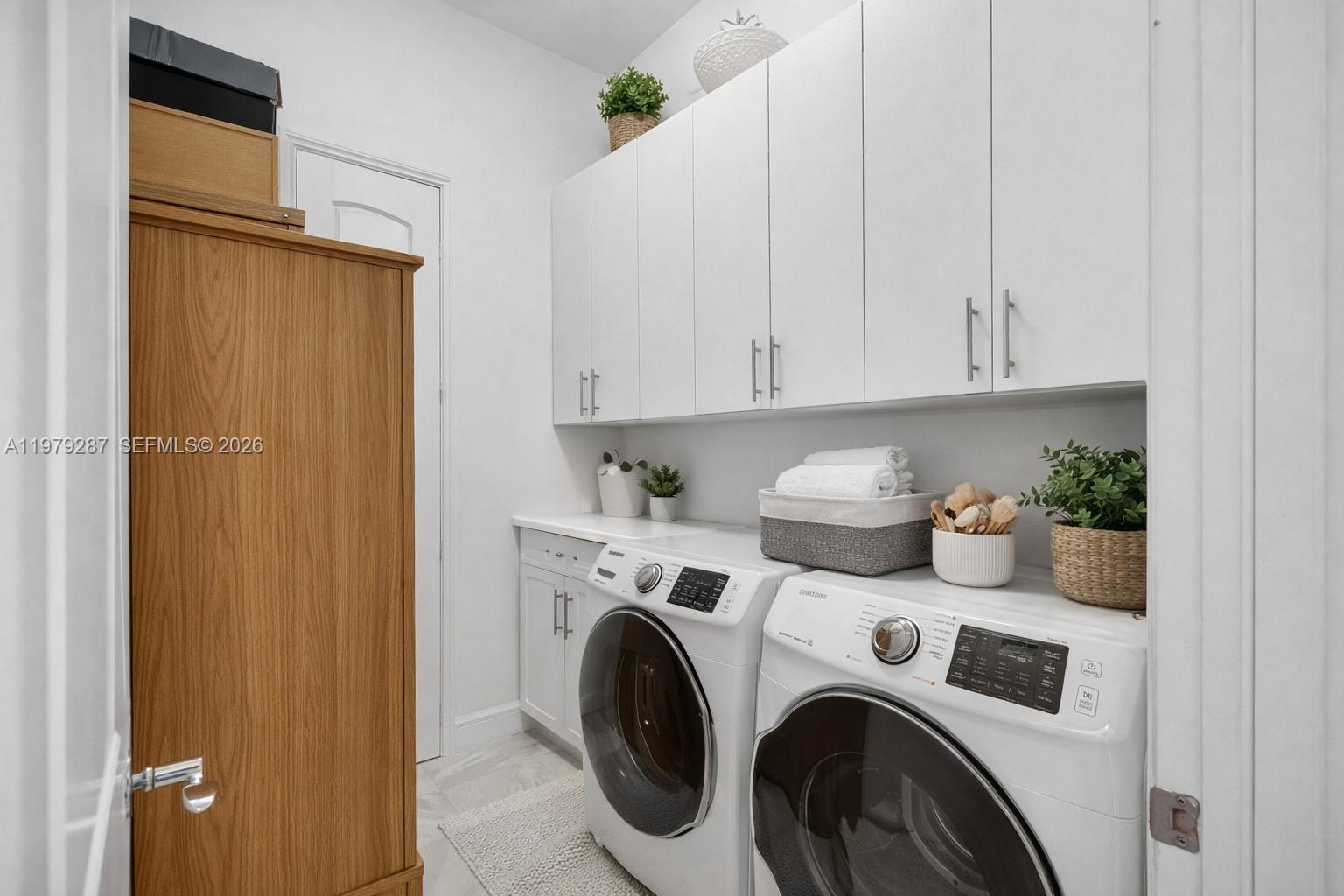 14929 Southwest 176th Terrace Miami, FL 33187 - Photo 25 of 40 a utility room with dryer and washer