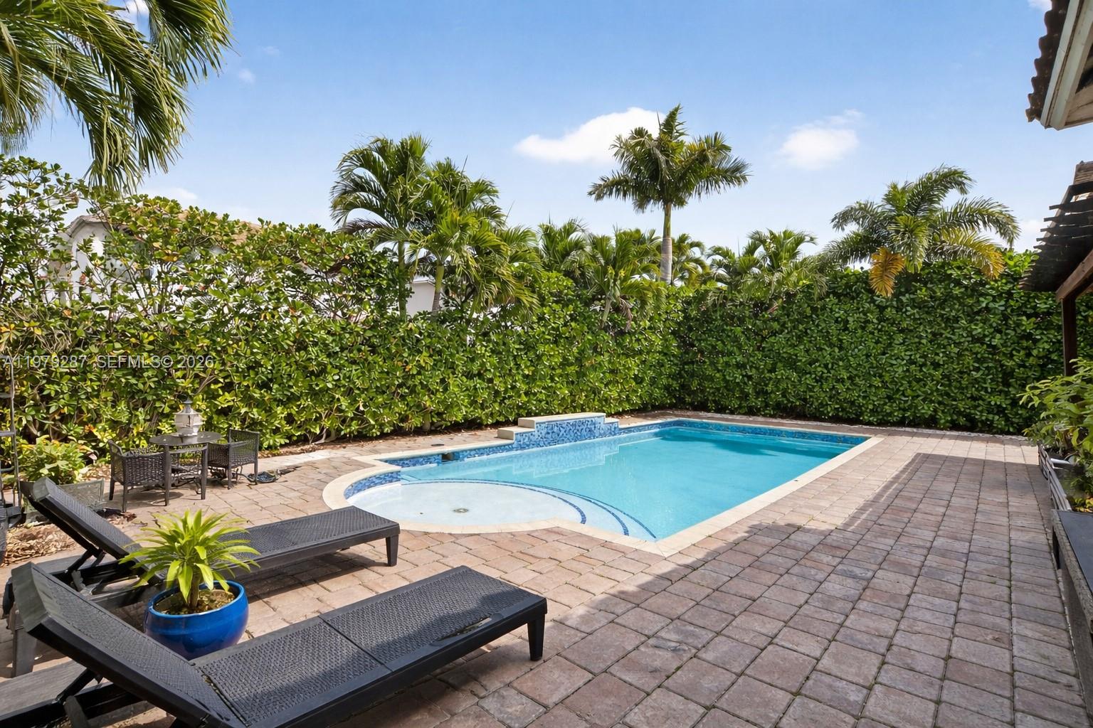 14929 Southwest 176th Terrace Miami, FL 33187 - Photo 26 of 40 a view of a swimming pool with a yard