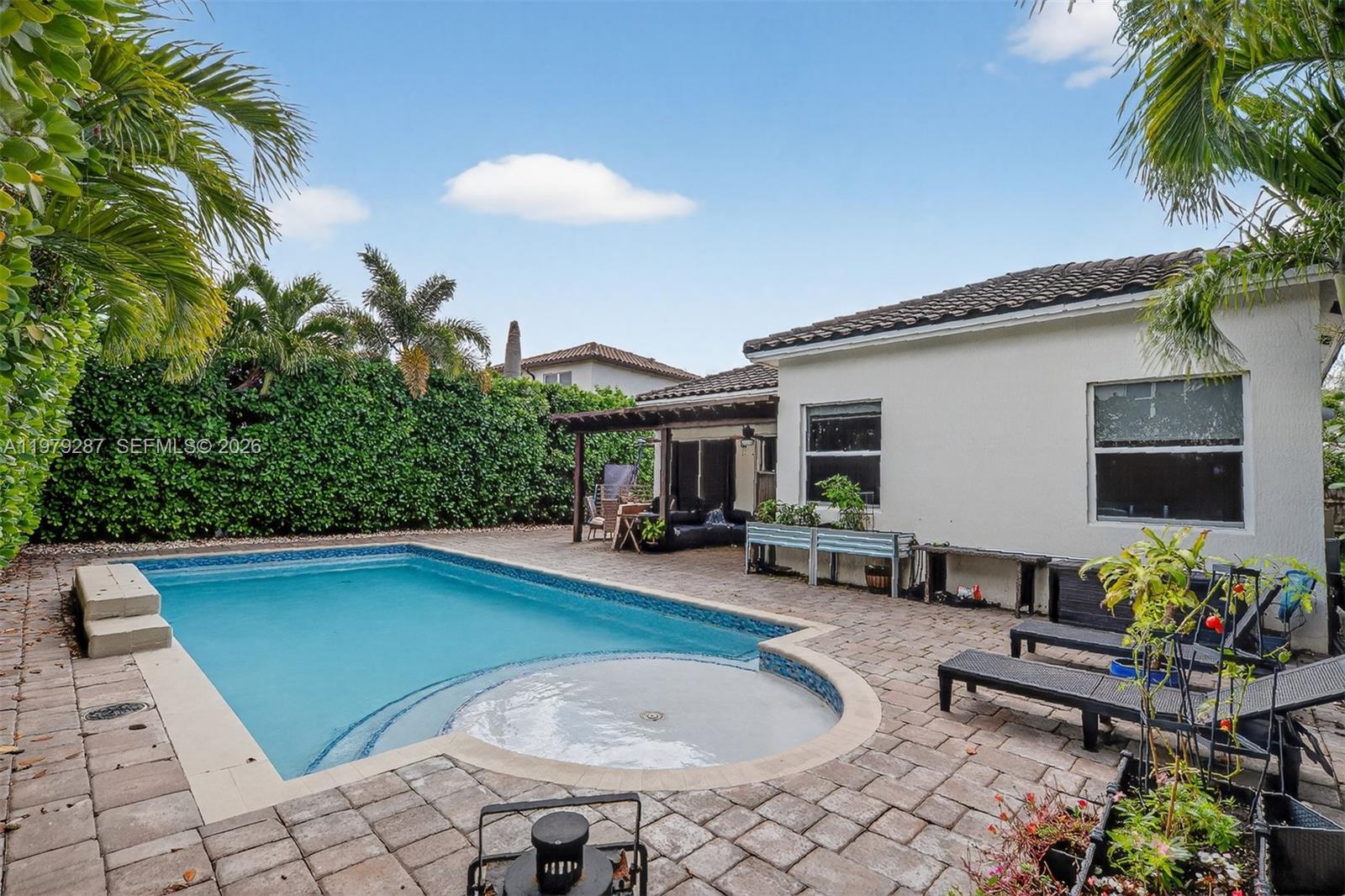 14929 Southwest 176th Terrace Miami, FL 33187 - Photo 27 of 40 a view of a house with swimming pool and sitting area