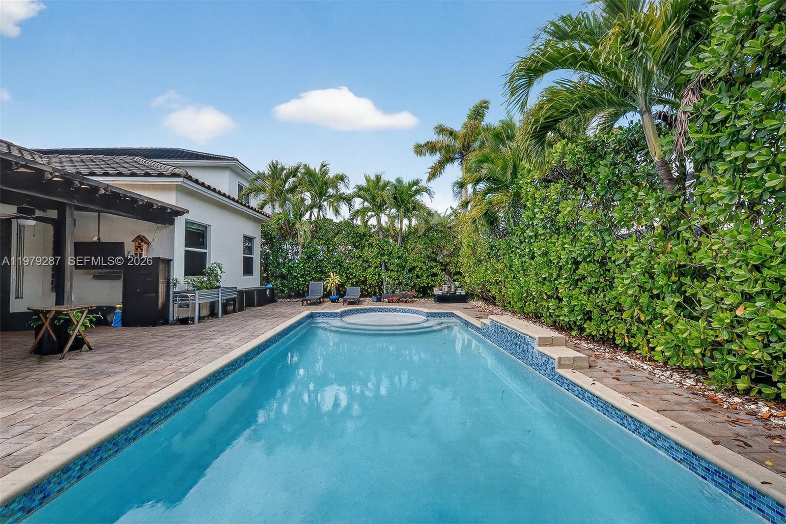 14929 Southwest 176th Terrace Miami, FL 33187 - Photo 28 of 40 a view of swimming pool with outdoor seating and plants