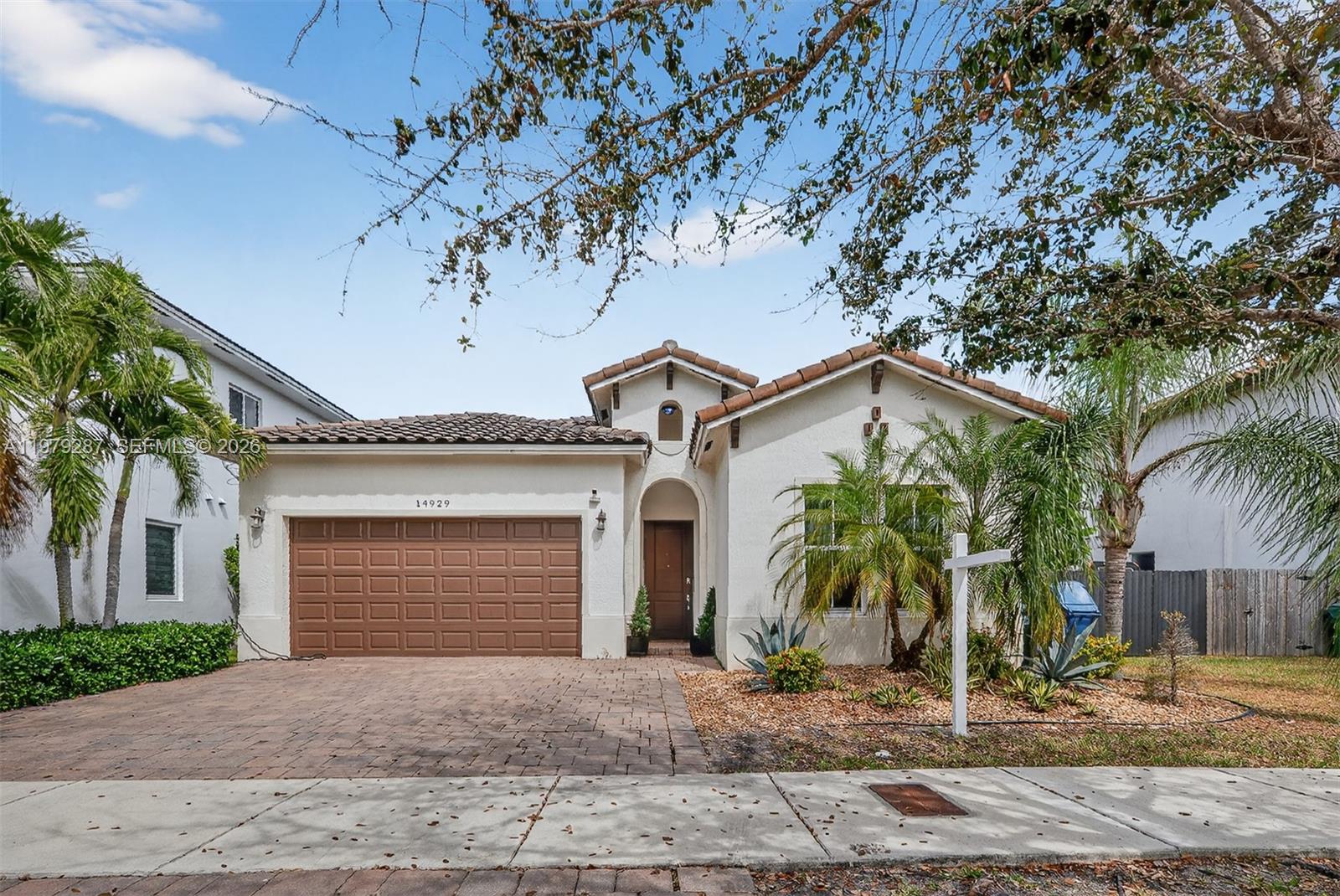 14929 Southwest 176th Terrace Miami, FL 33187 - Photo 3 of 40 a front view of a house with garden