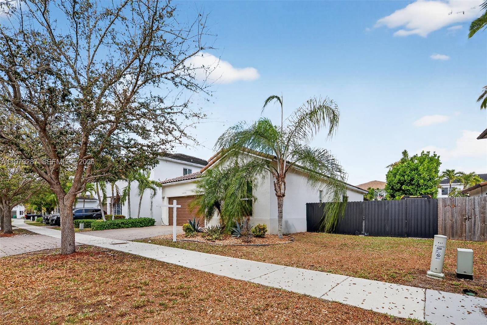 14929 Southwest 176th Terrace Miami, FL 33187 - Photo 35 of 40 a view of a house with a yard and large tree