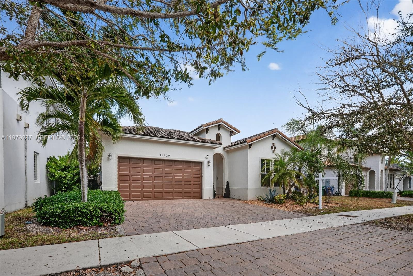 14929 Southwest 176th Terrace Miami, FL 33187 - Photo 36 of 40 a front view of a house with a yard and garage