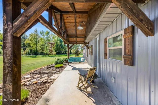 a view of a house with backyard porch and sitting area