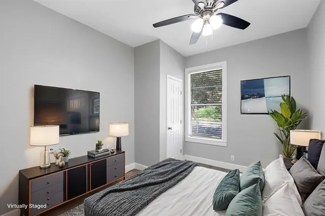 a bedroom with a bed and a flat screen tv