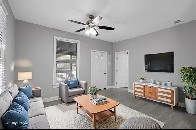 a living room with furniture and a flat screen tv