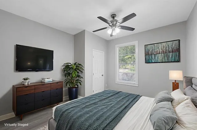 a bedroom with a bed and a flat screen tv