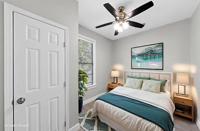 a bedroom with a large bed and a chandelier