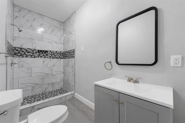 a bathroom with a sink toilet and shower