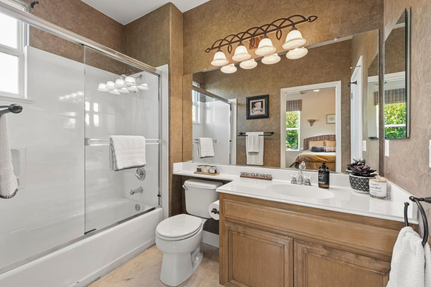 7466 Dunbar Court Gilroy, CA 95020 - Photo 37 of 103 a bathroom with a sink a toilet a mirror and shower