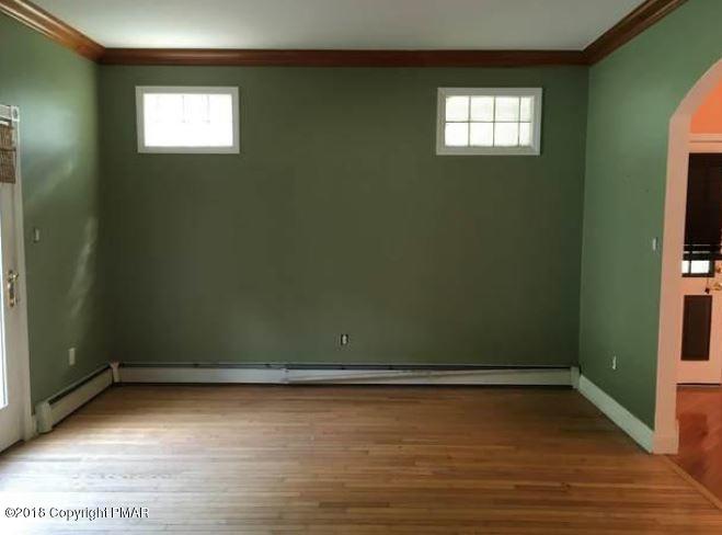 1090 Milford Road Dingmans Ferry, PA 18328 - Photo 11 of 13 wooden floor and window in an empty room