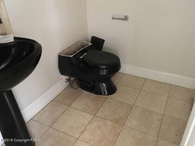1090 Milford Road Dingmans Ferry, PA 18328 - Photo 12 of 13 a bathroom with a toilet and a sink