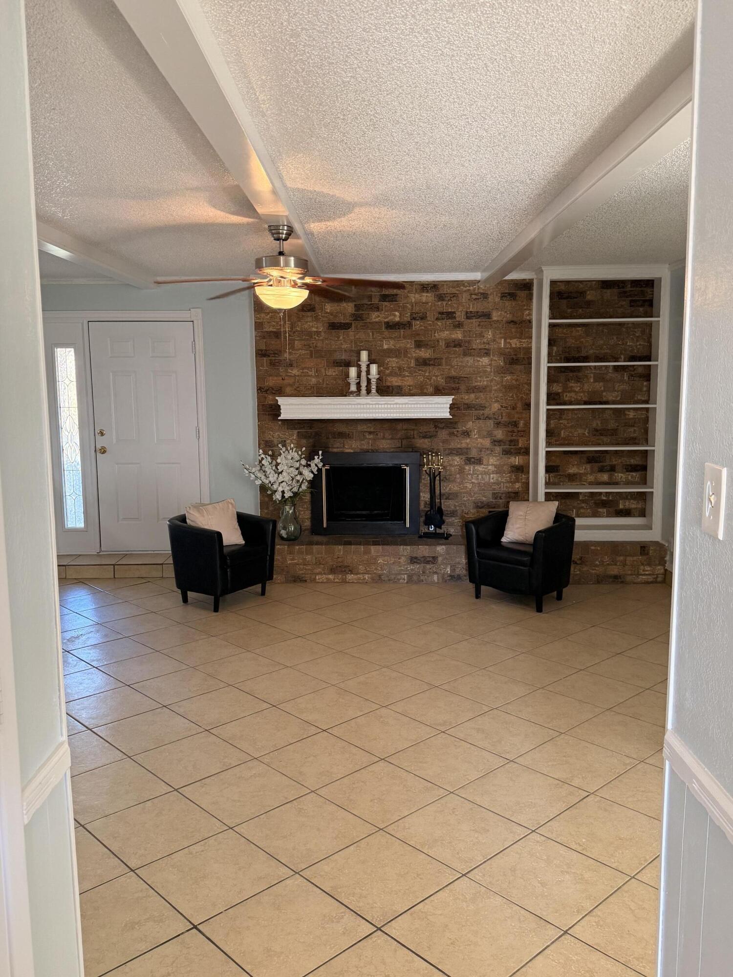 5510 Amherst Street Lubbock, TX 79416 - Photo 3 of 21 a living room with furniture and a fireplace