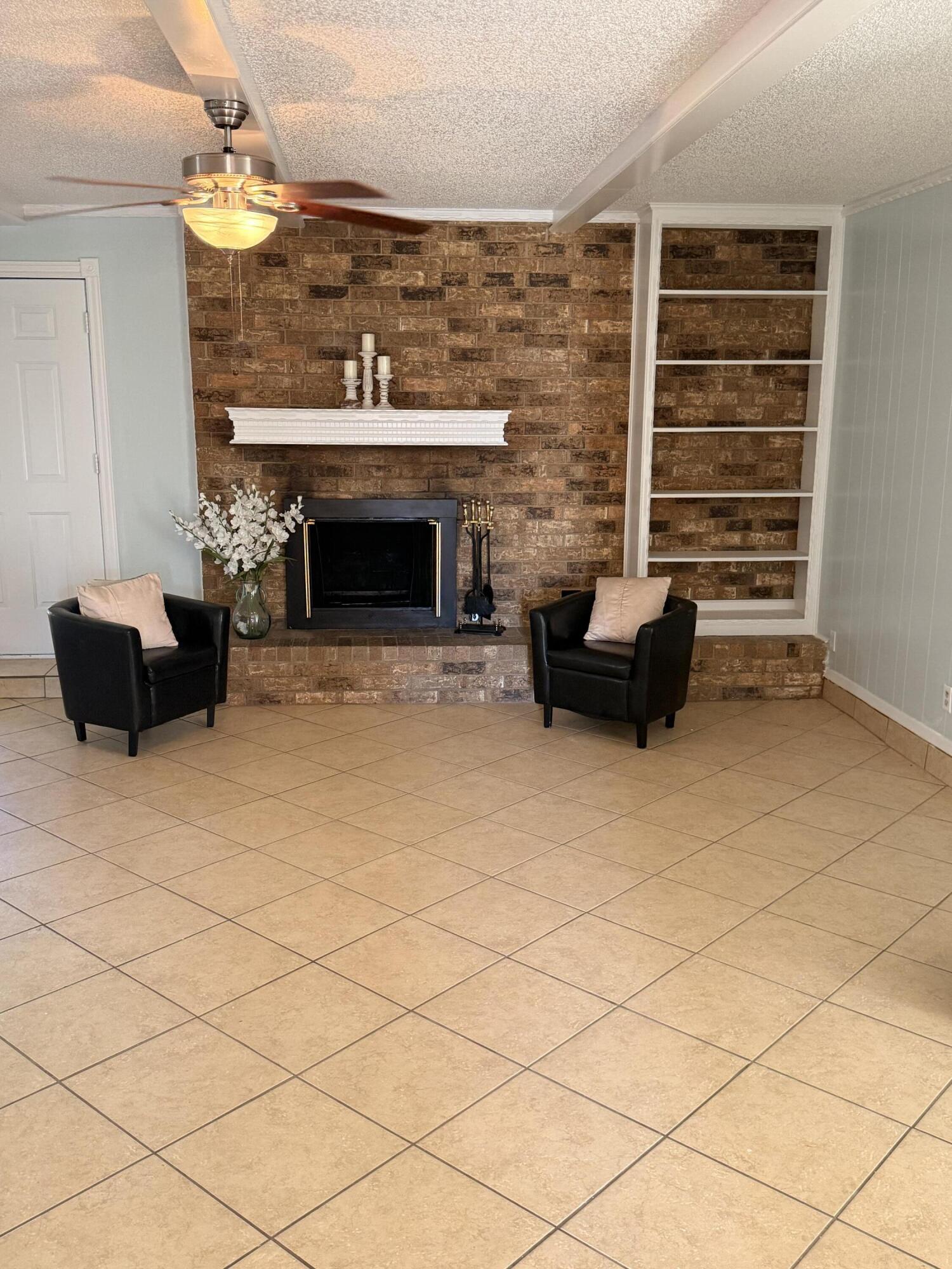 5510 Amherst Street Lubbock, TX 79416 - Photo 4 of 21 a living room with furniture and a fireplace