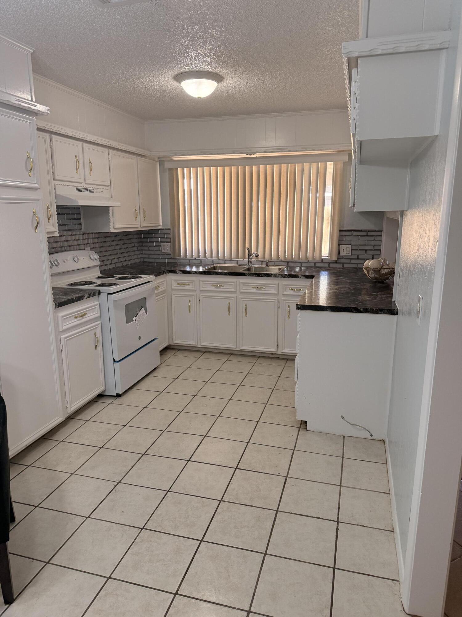 5510 Amherst Street Lubbock, TX 79416 - Photo 7 of 21 a kitchen with stainless steel appliances cabinets a sink and a stove