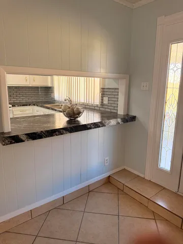 a kitchen with a sink a window and cabinets