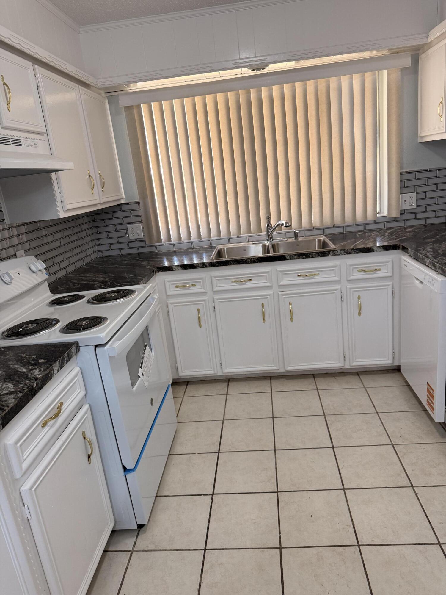 5510 Amherst Street Lubbock, TX 79416 - Photo 9 of 21 a kitchen with a stove a sink and cabinets