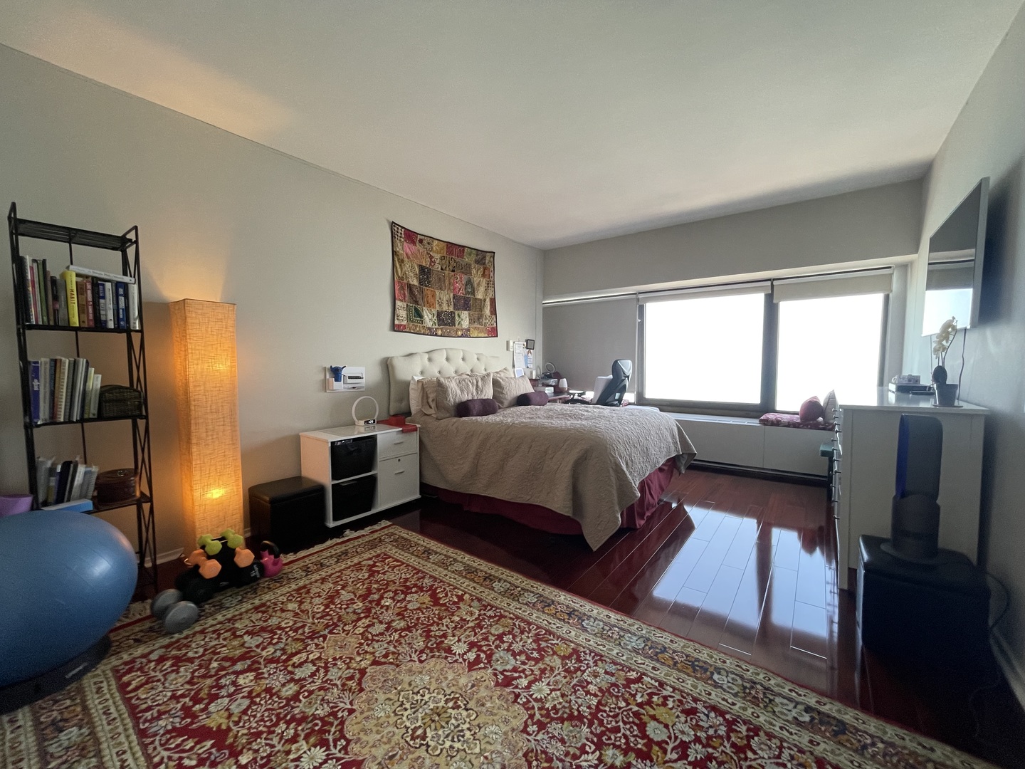 175 East Delaware Place, Unit 6706 Chicago, IL 60611 - Photo 21 of 30 a bedroom with a bed and wooden floor