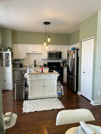 a kitchen with stainless steel appliances a refrigerator sink and microwave