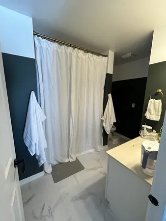 a living room with a couch and a tub