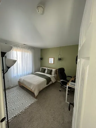 a bedroom with a bed and a window