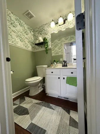 a bathroom with a sink a toilet and mirror