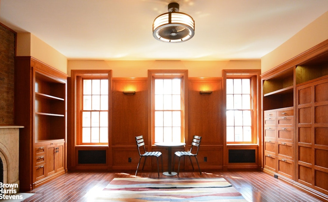 428 West 44th Street Manhattan, NY 10036 - Photo 12 of 17 a living room with hard wood floors and a window